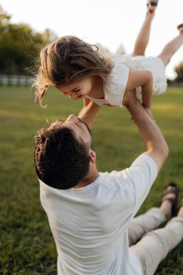 Father and Daughter Playing Outdoors on a Summer Day
